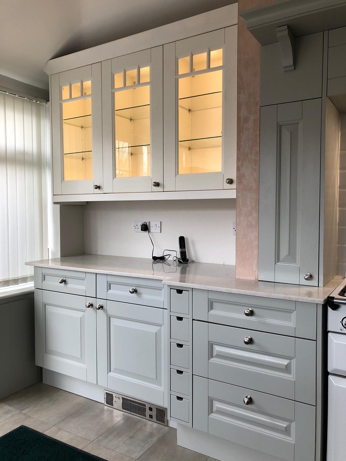 Fitted white kitchen worktop and cabinets