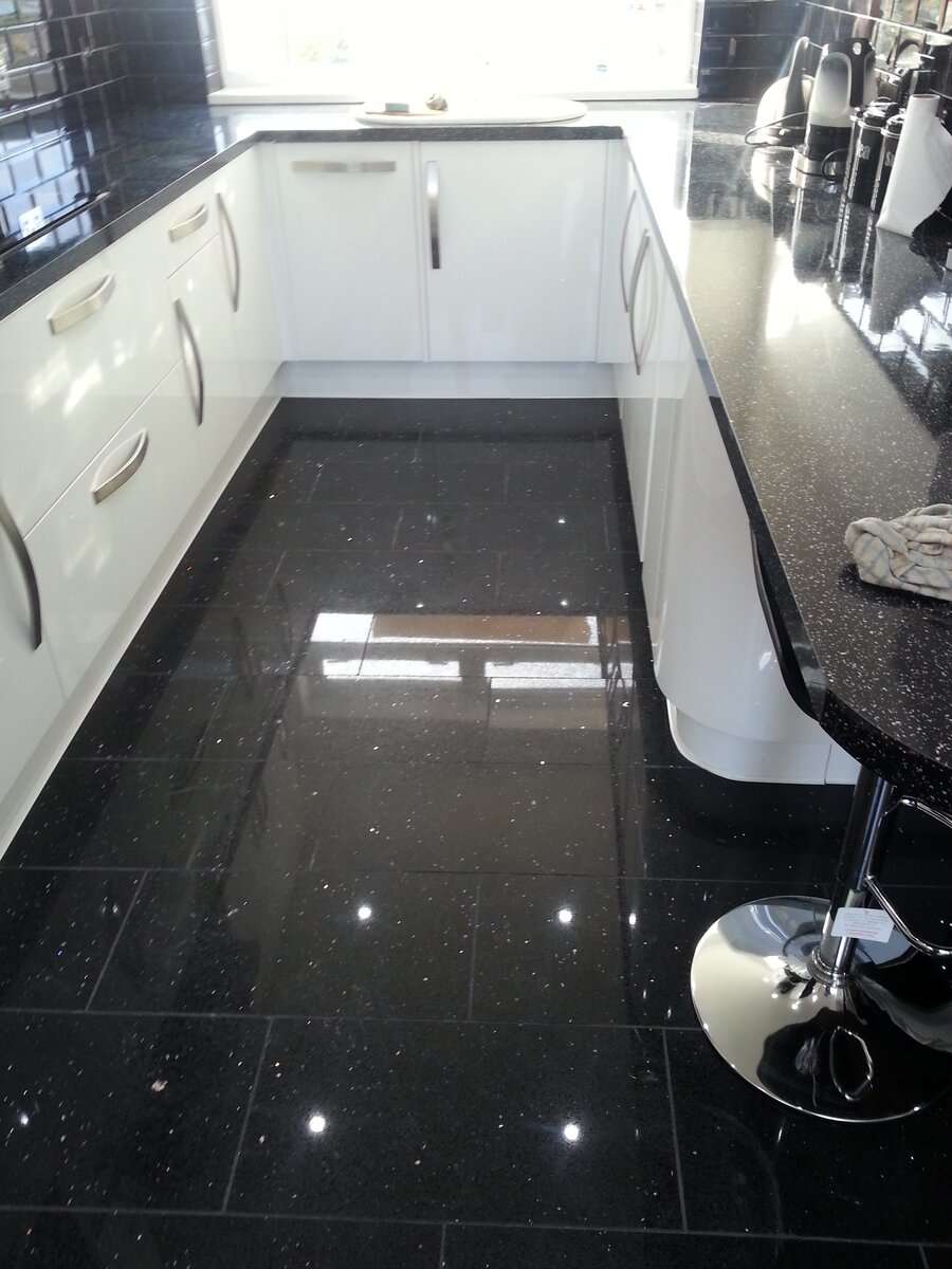 Black, sparkling kitchen with a gloss finish