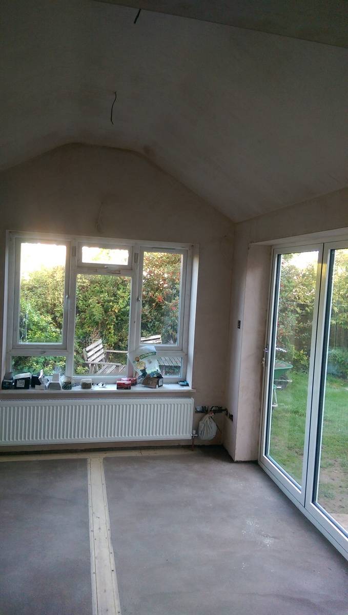 Indoor view of rear dinning room extension with vaulted ceiling and bifold doors
